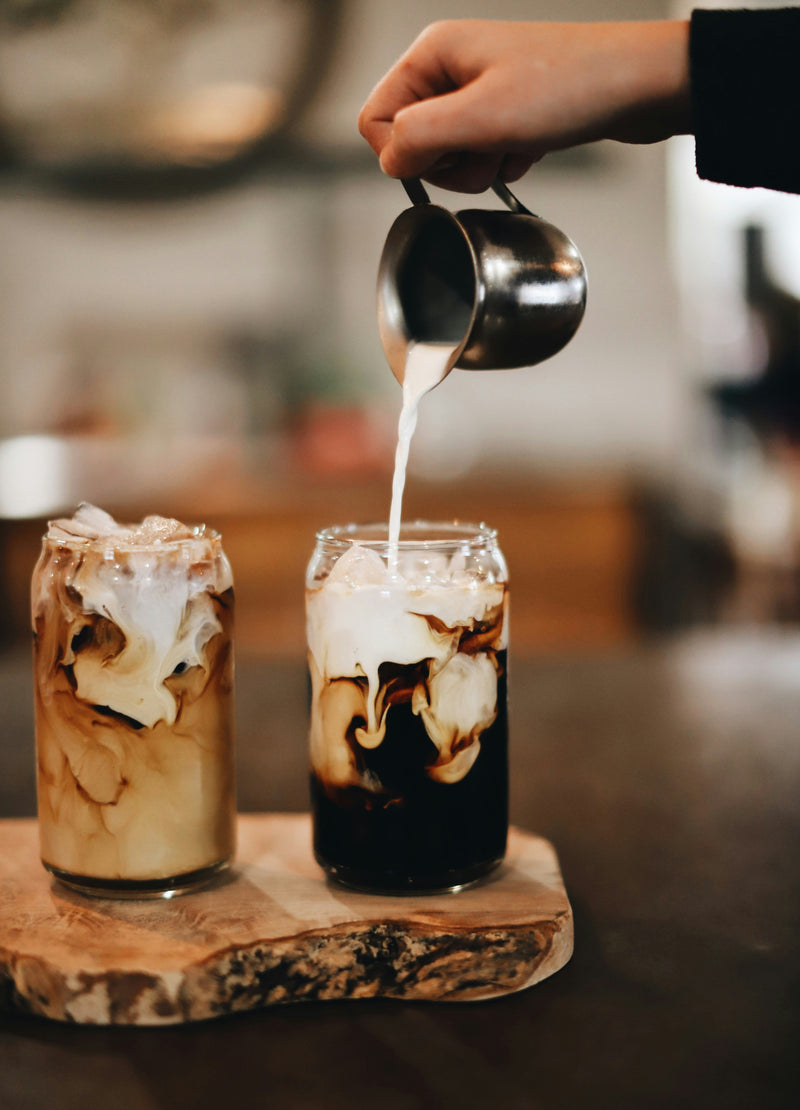 Iced coffee with Smoky Brown Sugar Syrup and cream swirling on top.